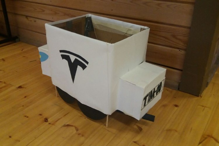 Iltaohjelman rekvisiittaa: Pahvista rakennettu Tesla-sähköauto.